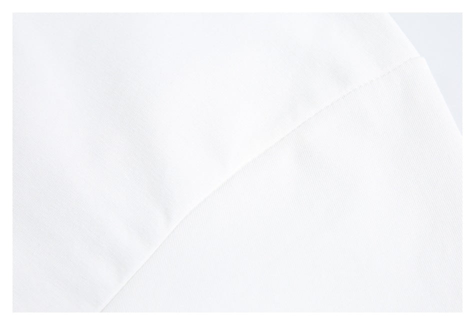 Close-up of a diagonal seam joining white garment fabric panels.