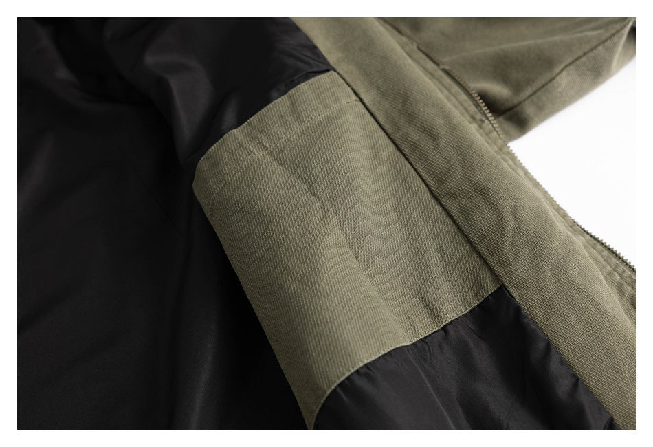 Close-up showing the olive jacket's black lining, inner seam, and zipper edge.