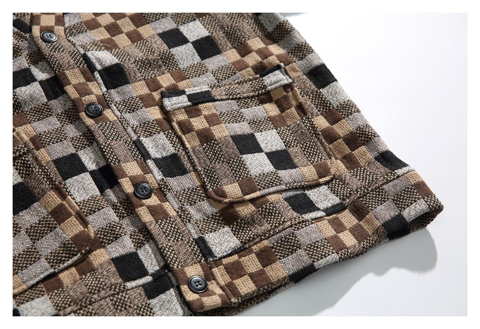 Close-up of a brown, tan, gray, and black check shirt showing its button placket and chest pocket.