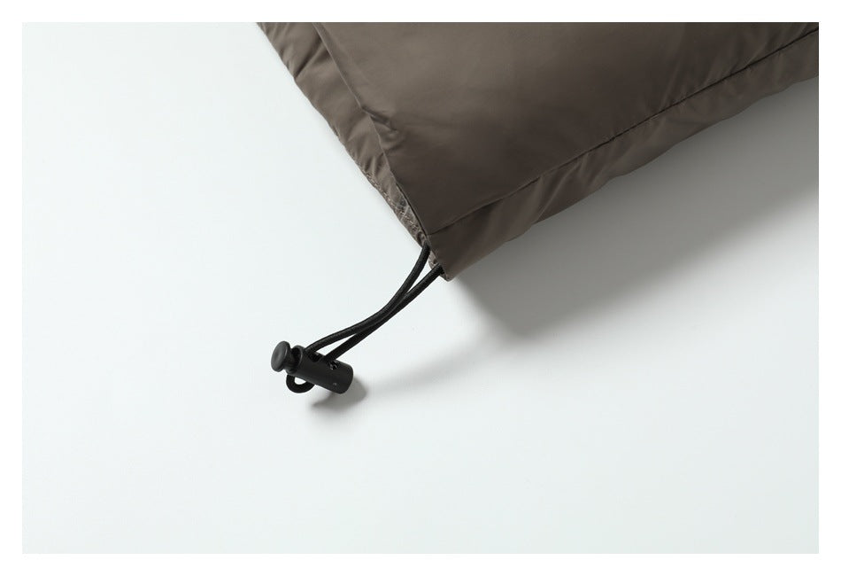 Close-up of the taupe jacket hem with a black drawcord and toggle.