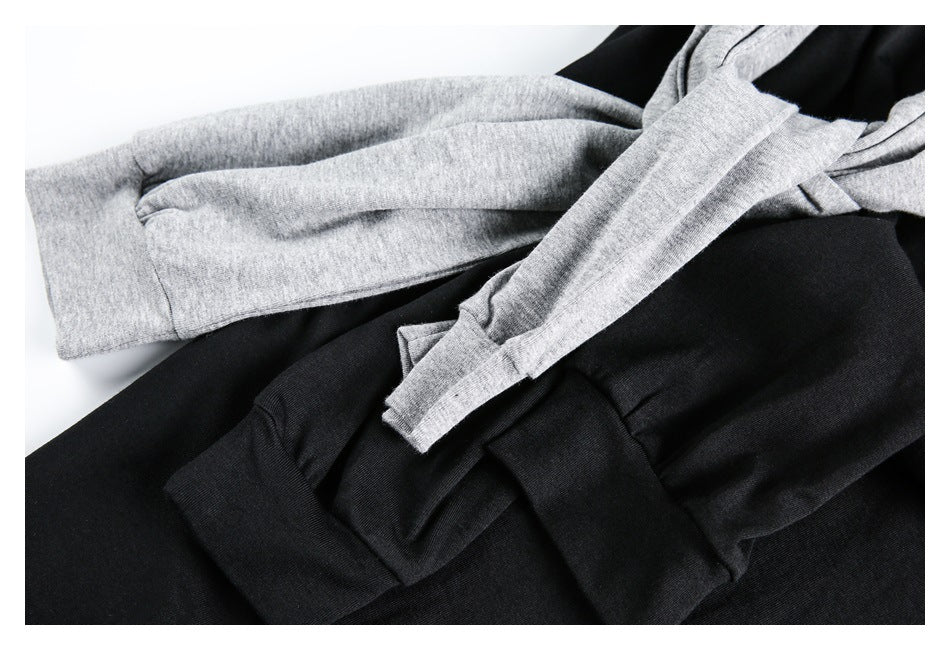 Close-up of gray and black tops showing long sleeves and ribbed cuffs.