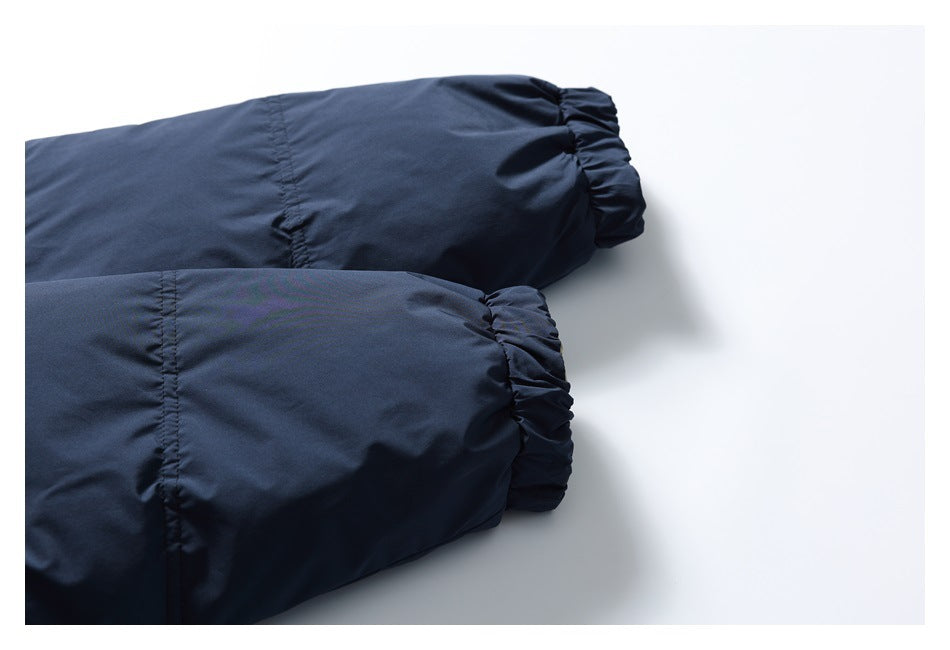 Close-up of the dark navy jacket's sleeves and gathered elastic cuffs.