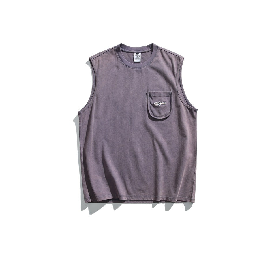 Front of a muted purple sleeveless shirt with a chest pocket and small embroidered emblem, displayed flat.