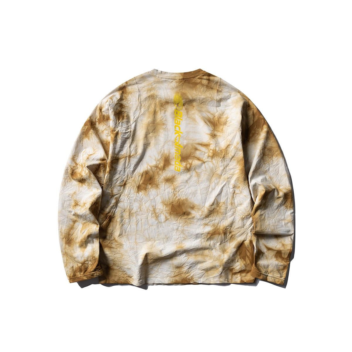 Flat lay of a cream and ochre tie-dye long-sleeve crewneck shirt, back view, with vertical yellow lettering.