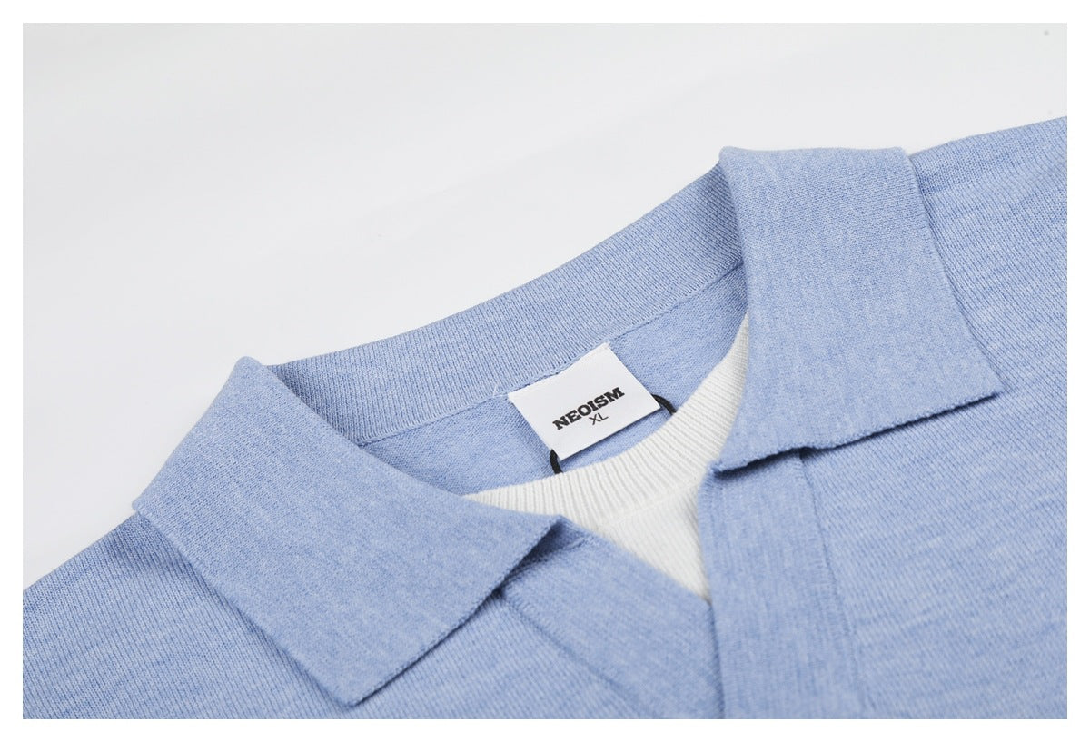 Close-up of the light blue polo's collar, neckline, and sewn-in NEOSISM XL label.
