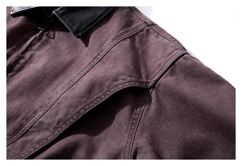 Close-up of a muted plum-brown jacket showing the shoulder seam and dark collar.
