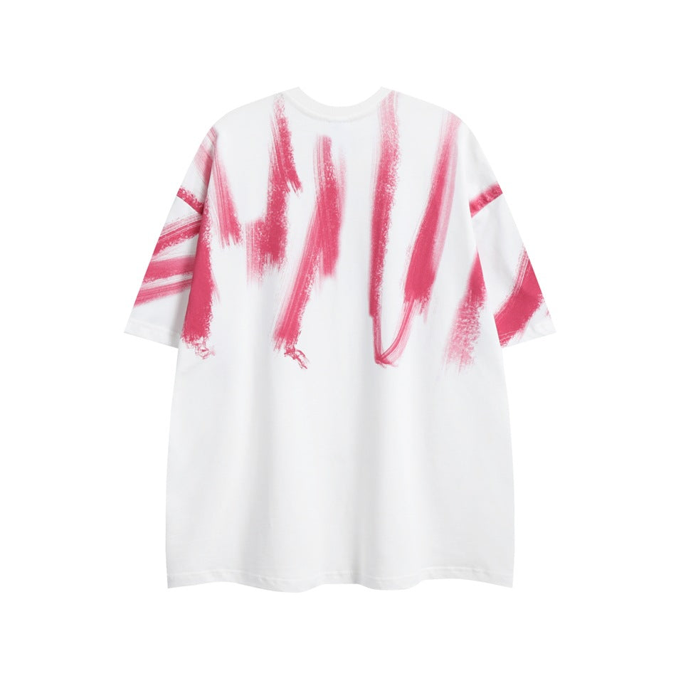 Front view of a loose white T-shirt with large pink brushstroke graphics.
