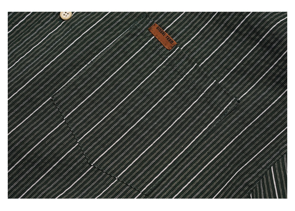 Close-up of the striped shirt fabric, a pocket seam, and a small brown sewn-on label.