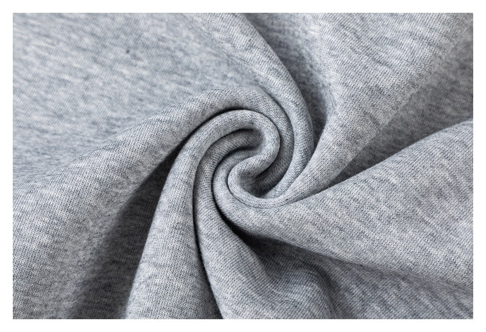 Close-up of the gray top's fabric gathered into a spiral to show its texture.