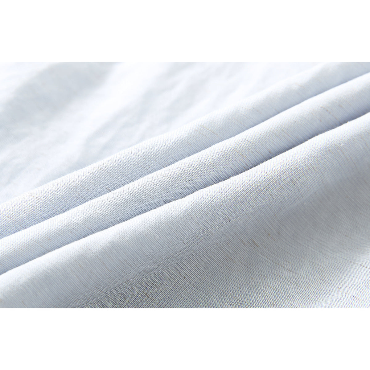 Close-up showing the subtle woven texture of pale blue-gray shirt fabric.