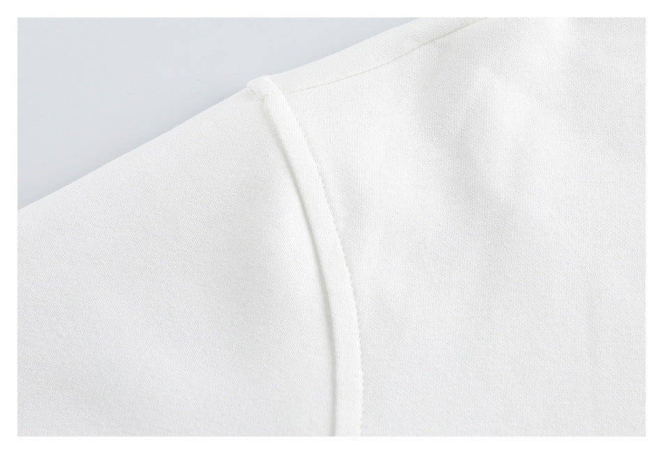 Close-up of white sweatshirt fabric and a shoulder seam.