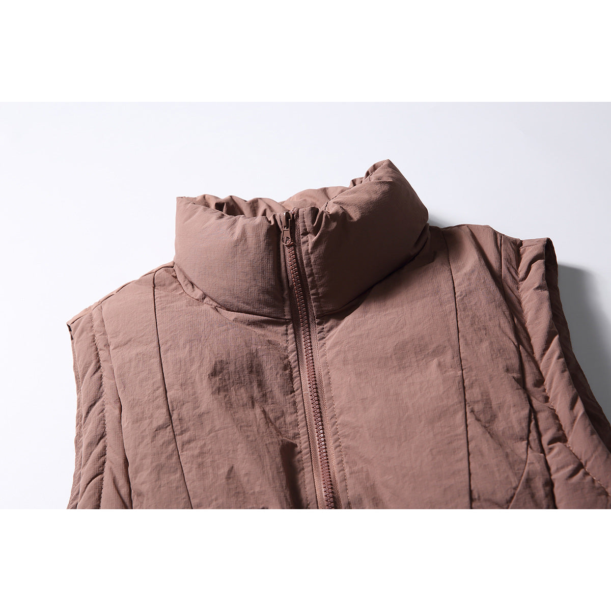 Close-up of the dusty mauve vest’s gathered high collar, front zipper, and upper panels.