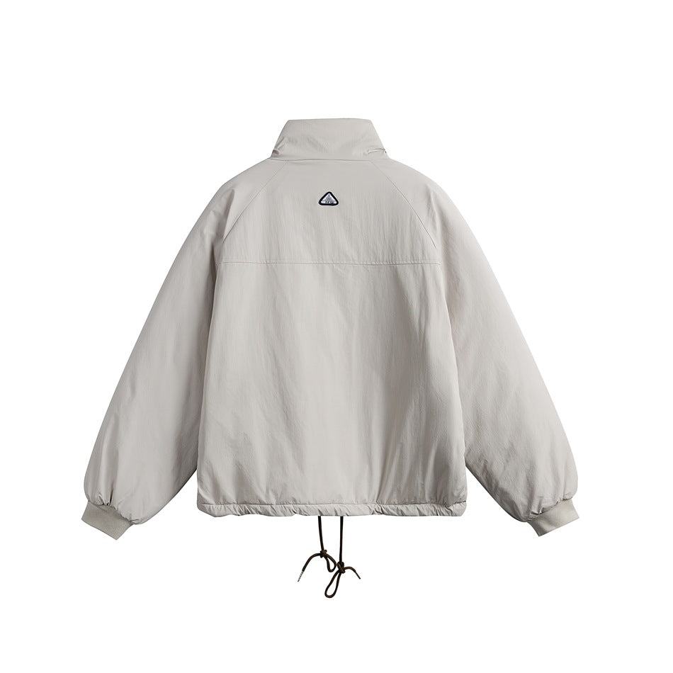 Back view of a light gray jacket with a stand collar, raglan sleeves, and an adjustable hem cord.