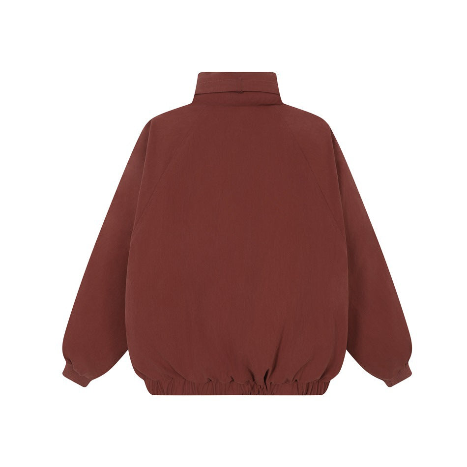Back view of a burgundy jacket with a high collar, raglan sleeves, and gathered hem.