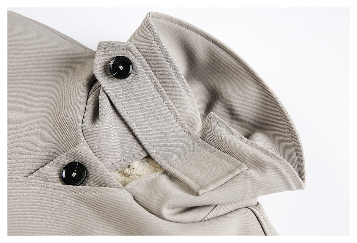 Close-up of the gray jacket's pointed collar, black buttons, stitching, and cream lining.