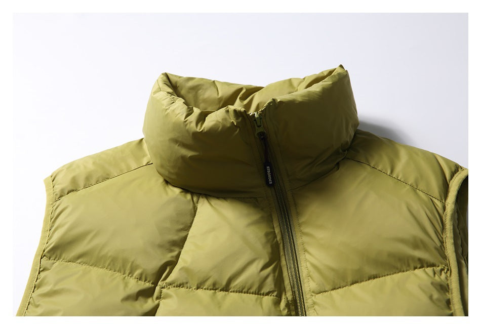Close-up of the olive-green vest's padded stand collar, front zipper, and upper quilted panels.