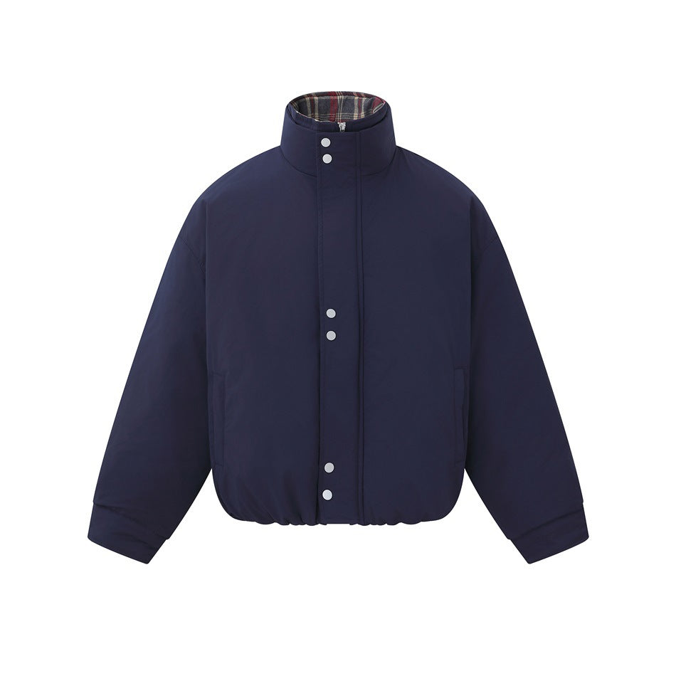 Navy puffer jacket flat lay, front view, with stand collar, snap-and-zip placket, side pockets and plaid collar interior