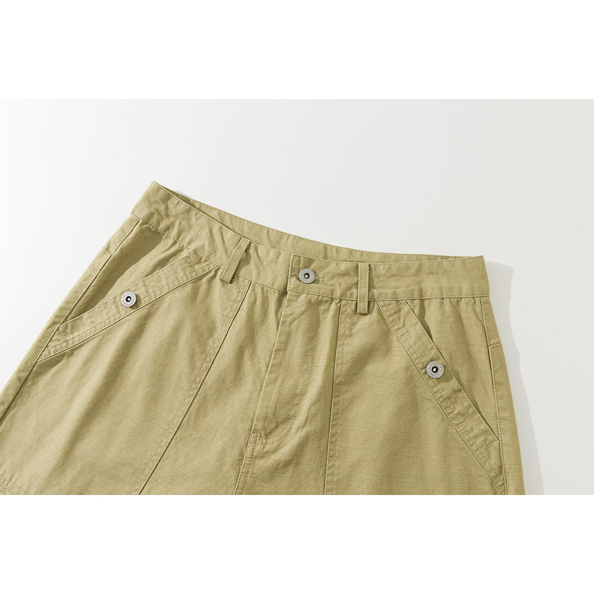 Close-up of khaki shorts showing the waistband, button closure, belt loops and angled front pockets.