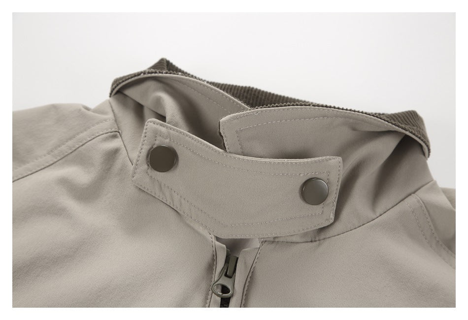 Close-up of the jacket's raised collar, snap-button throat tab, and upper zipper.