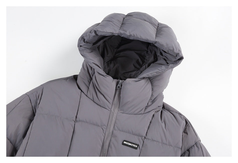 Close-up of a gray puffer jacket showing its hood, front zipper, and small chest badge.