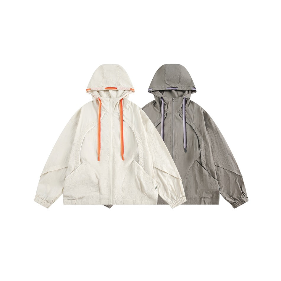 Two hooded jackets shown from the front: ivory with orange trim and gray with lavender trim.