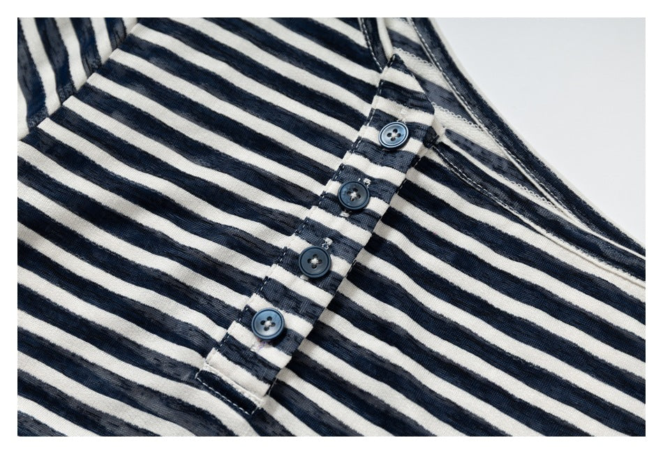 Close-up of the navy and cream striped top’s four-button placket and wide neckline.