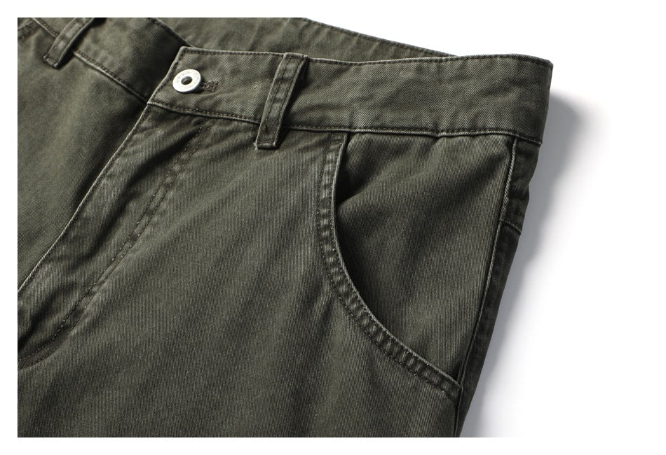 Close-up of the pants' waistband, button, belt loop, and curved front pocket.