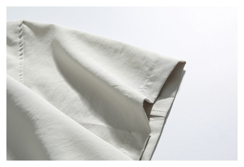 Close-up of a light ivory shirt sleeve and stitched sleeve opening.