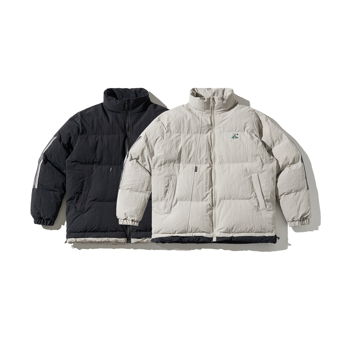 Front view of two high-collar padded jackets, one black and one light beige, with zip fronts and side pockets.