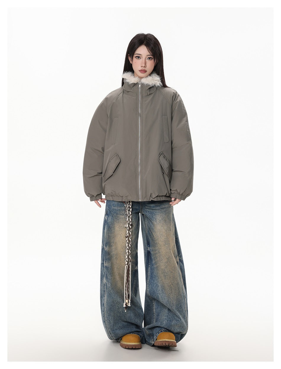 Full-length front view of a model wearing a taupe-gray fur-collar jacket and wide-leg faded jeans.