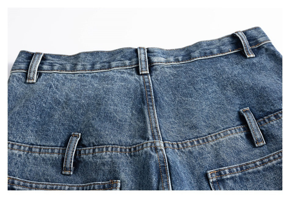 Cropped rear view of blue jeans showing the waistband, belt loops, center seam, and upper back pockets.