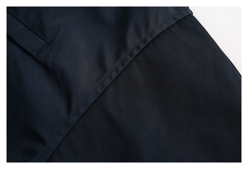 Close-up of navy jacket fabric and a diagonal stitched seam.