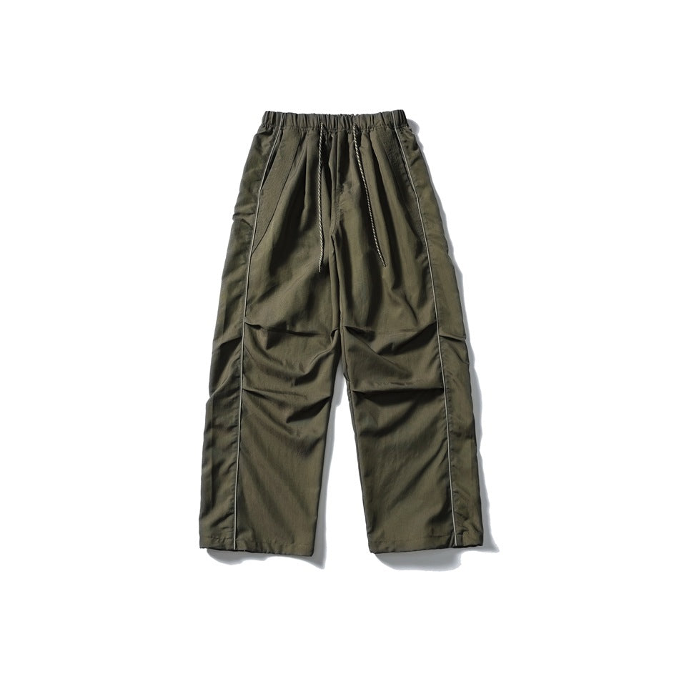 Army green wide-leg drawstring pants with light side piping and knee pleats, flat lay front view
