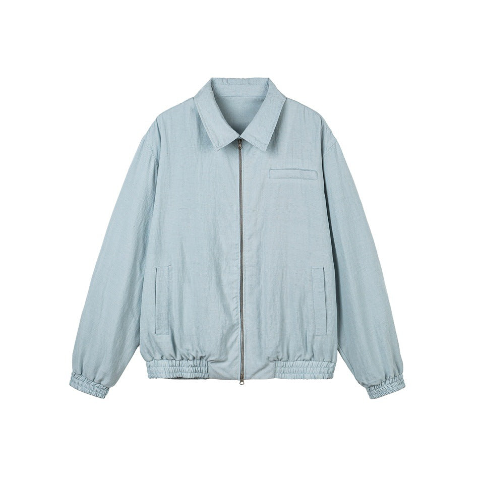 Front view of a pale blue collared jacket with a center zipper, chest pocket, side pockets and elastic cuffs and hem.