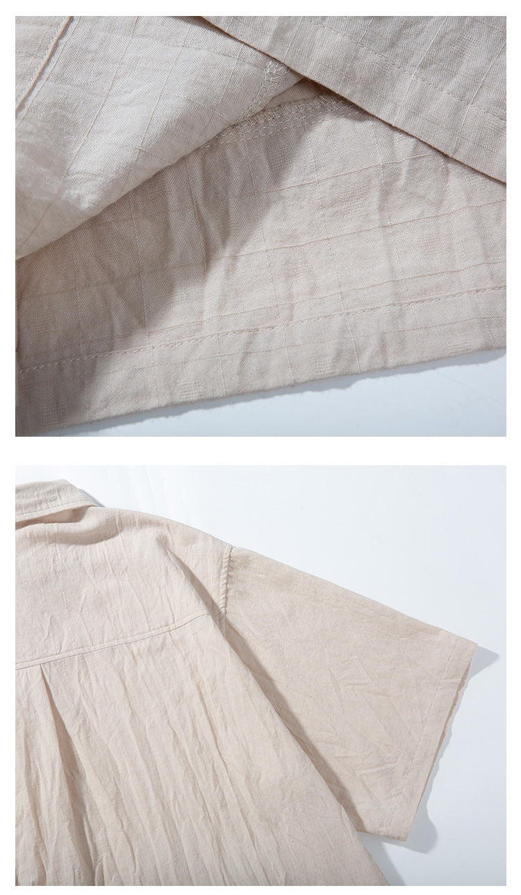 Close-up of a light beige garment showing stitched fabric panels, a seam, and a short sleeve laid flat.