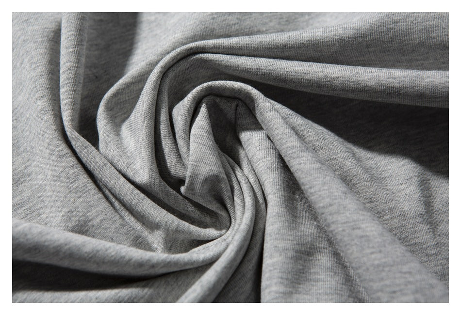 Close-up of heather gray T-shirt fabric arranged in soft folds.