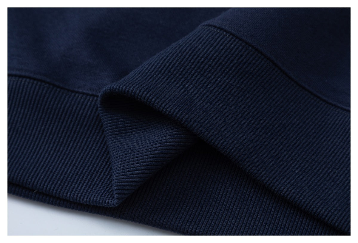 Close-up of navy ribbed garment hem and cuffs.