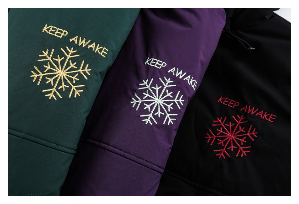 Three dark green, purple, and black garment panels with embroidered “KEEP AWAKE” text and snowflakes.