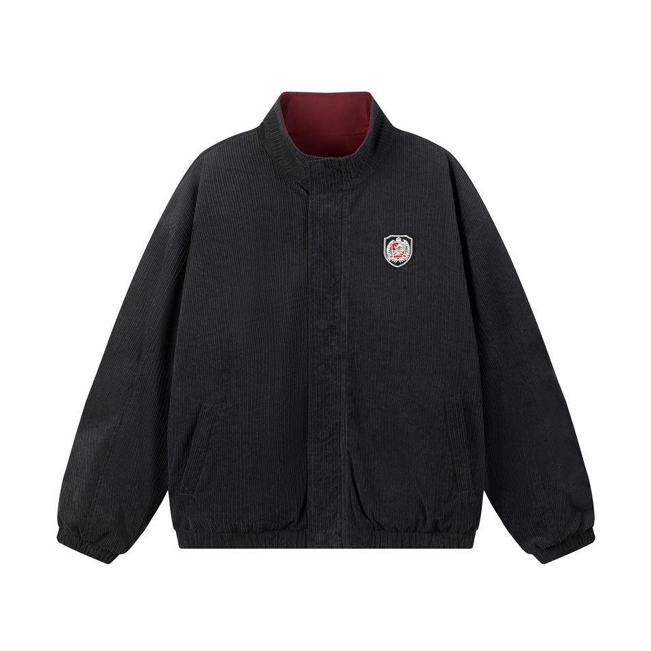 Front view of a black ribbed jacket with a stand collar, concealed front closure, two pockets, and a chest crest.