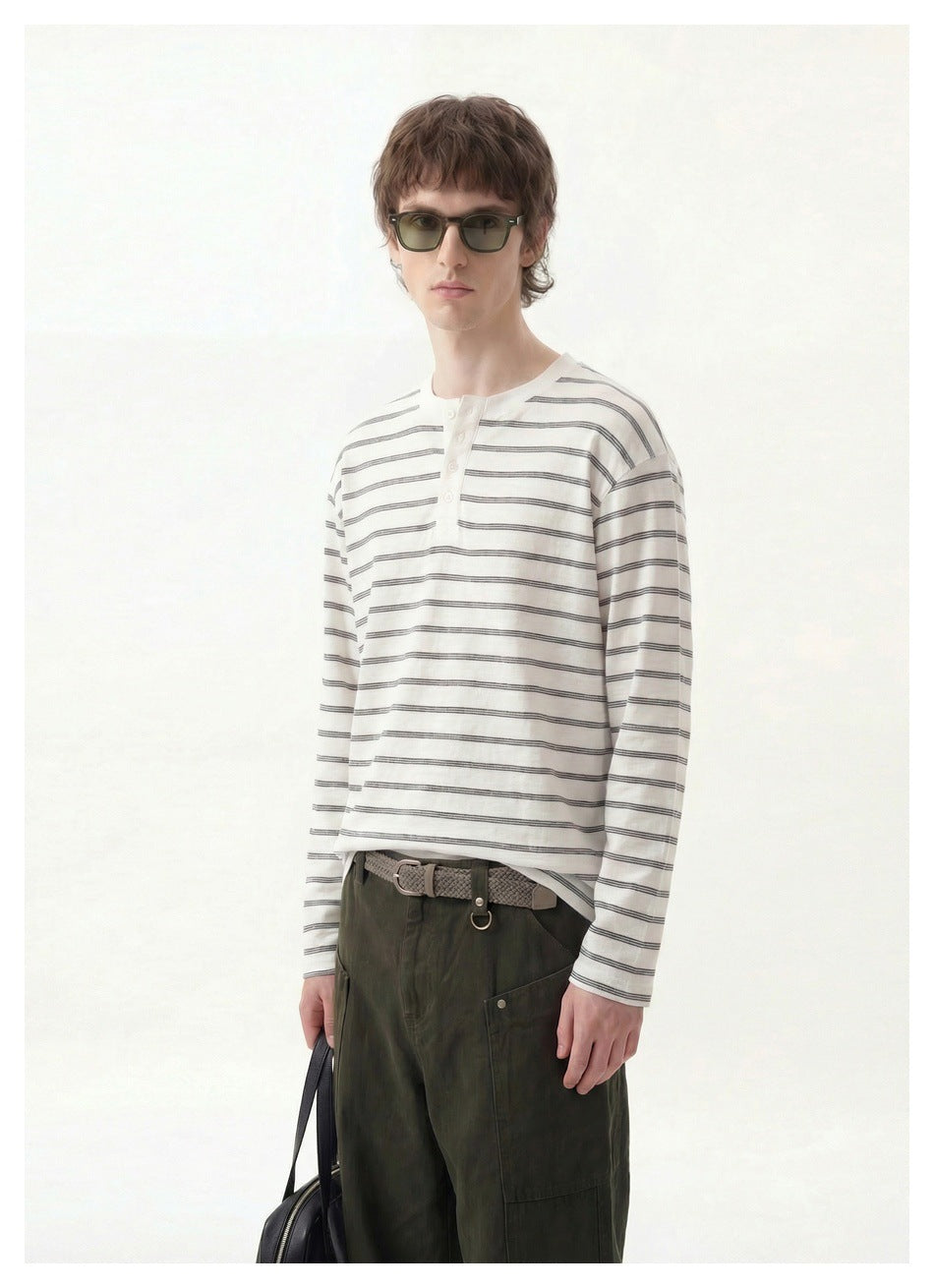 Model in a white and gray striped long-sleeve henley, shown from the front at three-quarter angle.