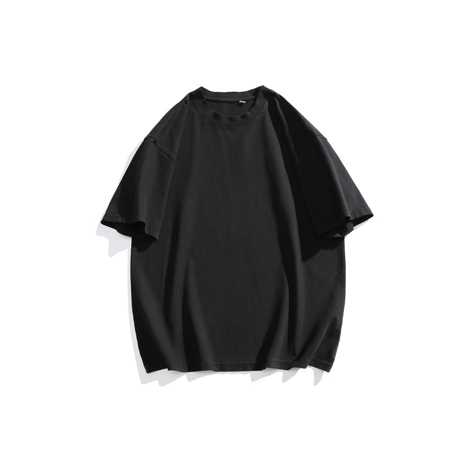 Black short-sleeve crew neck T-shirt with dropped shoulders, flat lay on a white background