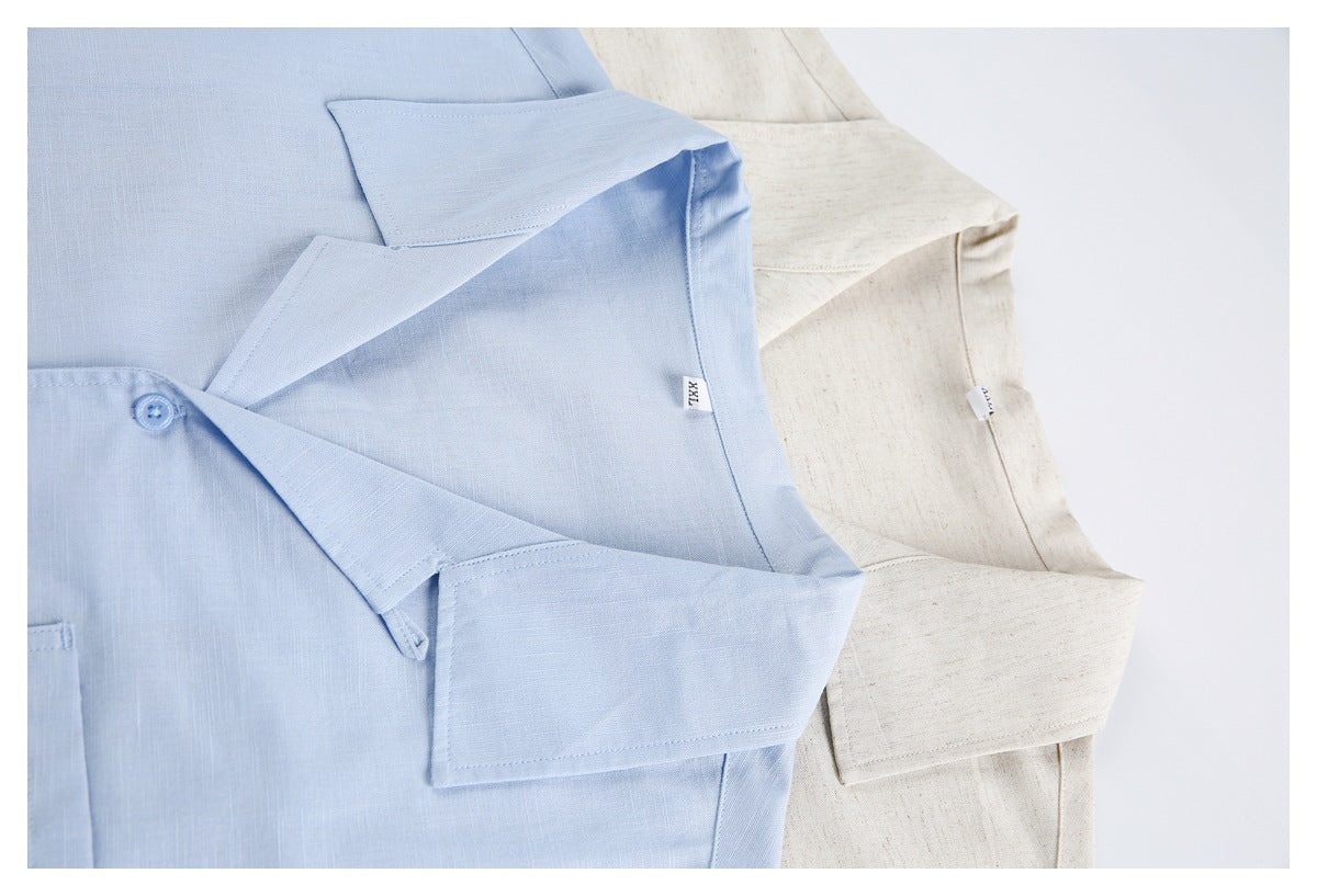 Close-up of overlapping light blue and cream shirts, showing their wide collars and short sleeves.