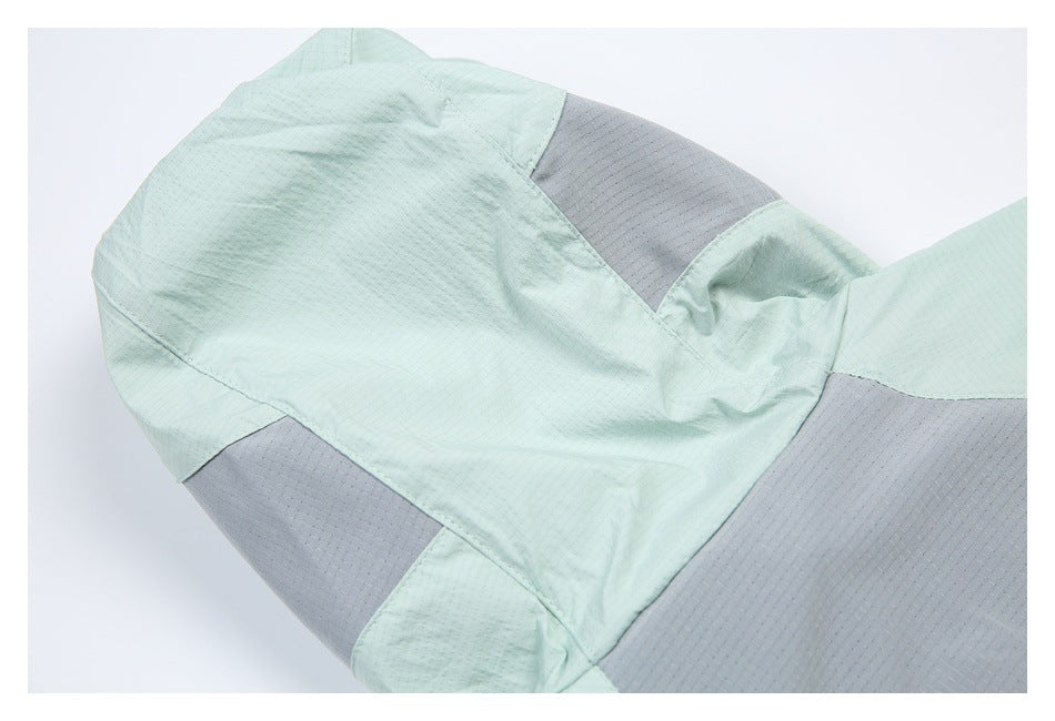 Close-up of pale mint jacket panels and gray inserts around the shoulder area.