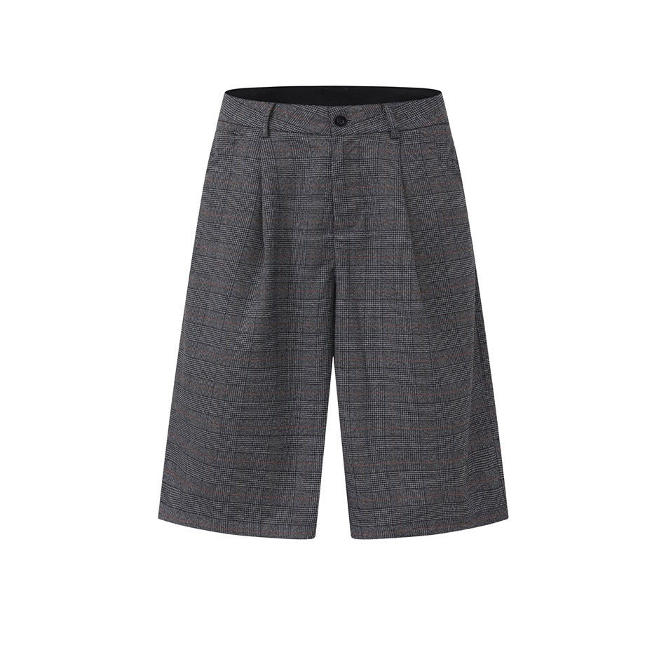 Dark gray plaid knee-length shorts with front pleats, button waistband and belt loops on a white background