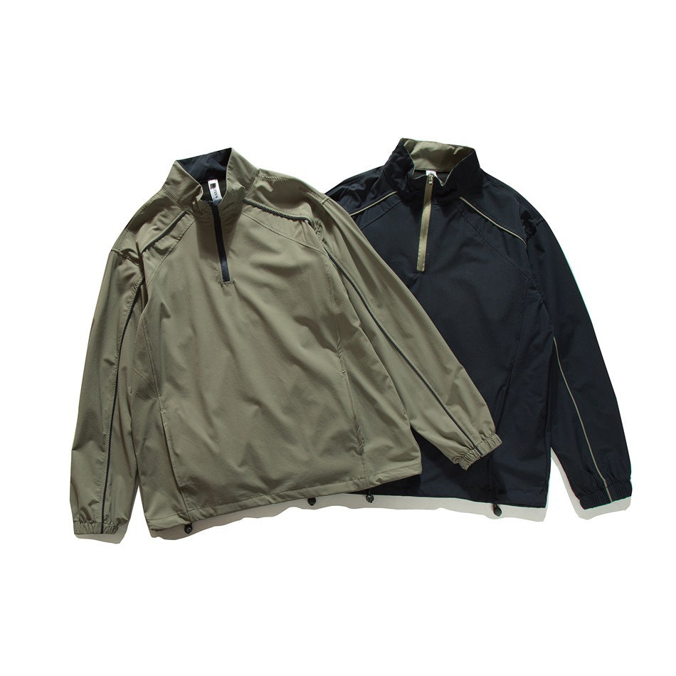 Two lightweight quarter-zip jackets shown together: one olive-gray and one black, both with stand collars.