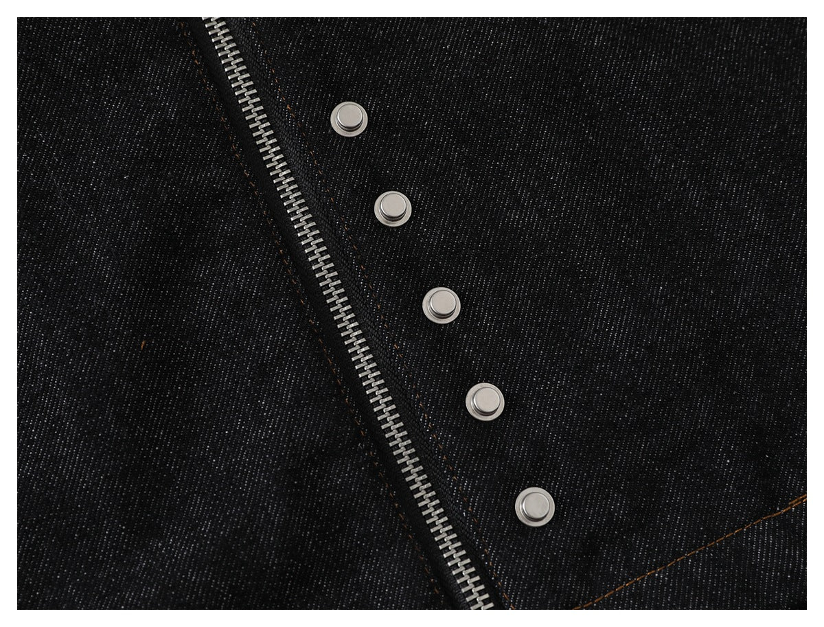 Dark denim detail showing a silver zipper and a row of five metal snaps.