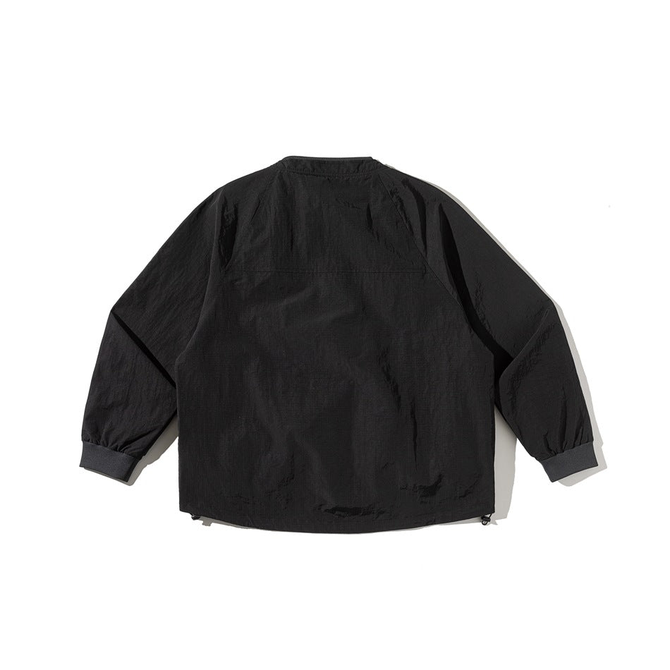 Back view of a black jacket with raglan sleeves, elastic cuffs, and a plain body.