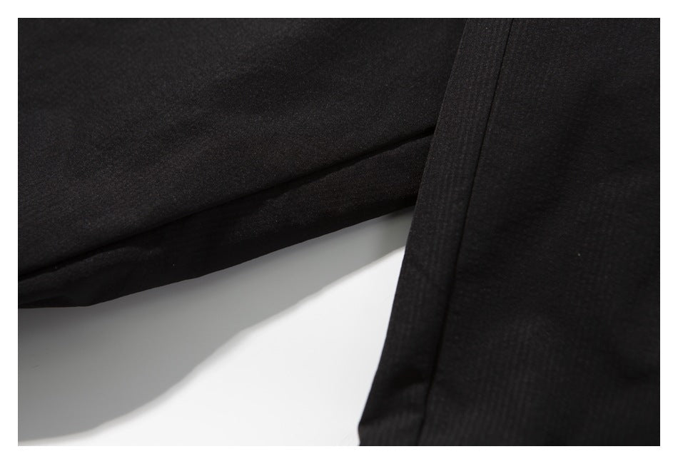Close-up of black garment fabric and stitched edges.