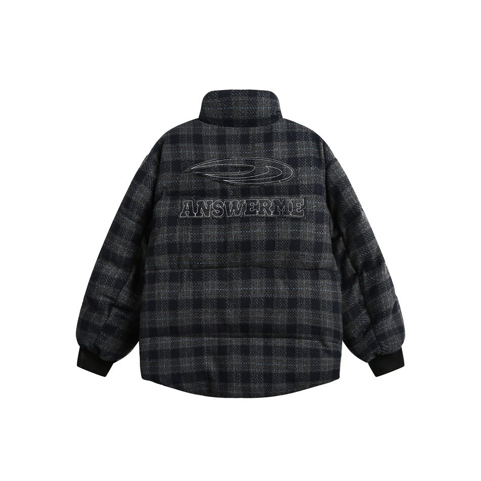 Back of a dark charcoal plaid jacket with a high collar, ribbed cuffs, and outlined embroidery.