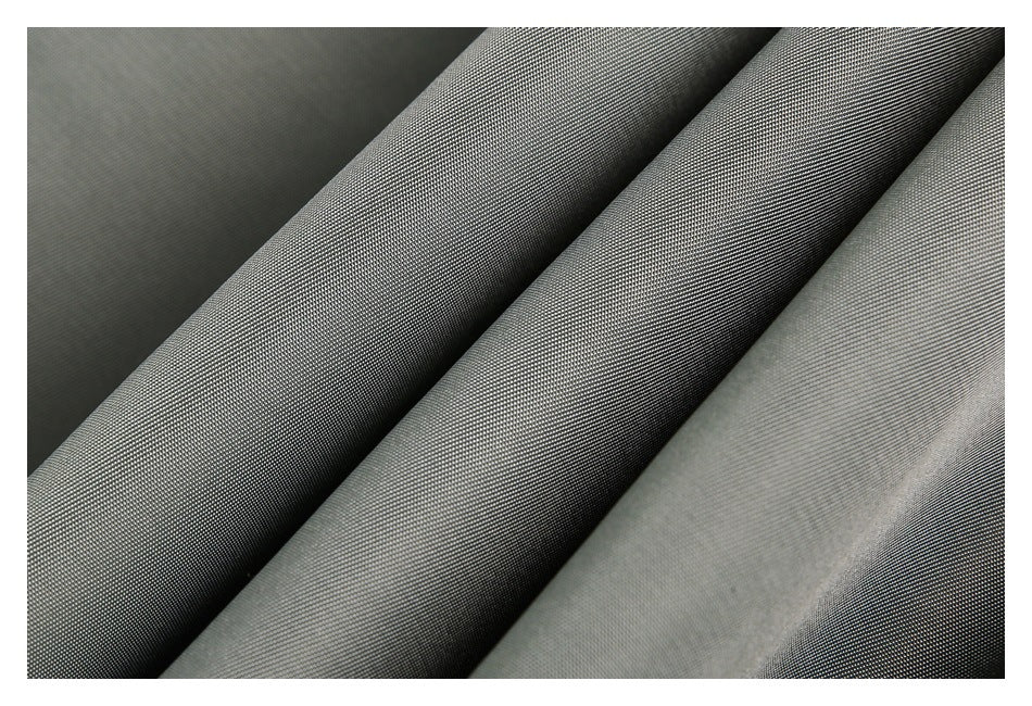 Close-up of dark gray woven fabric folded into several ridges, showing its fine texture.
